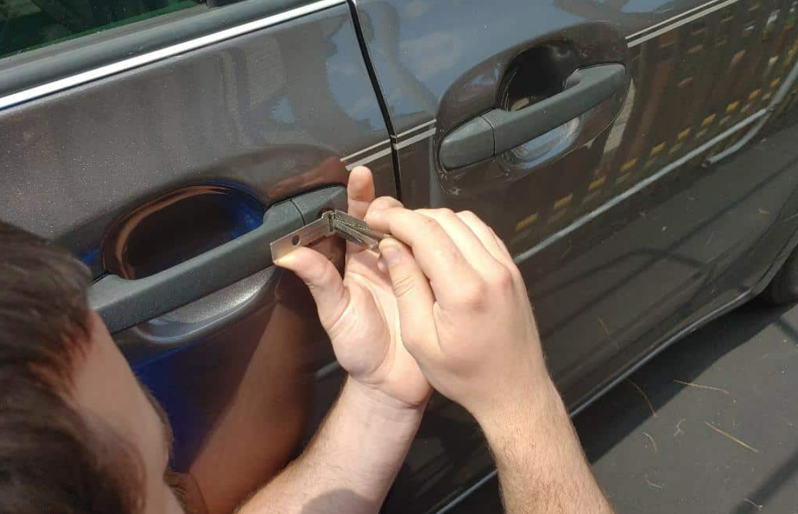 Alt text: "ABC Locksmith Ohio technician unlocking a car door with professional tools in Columbus, Ohio"