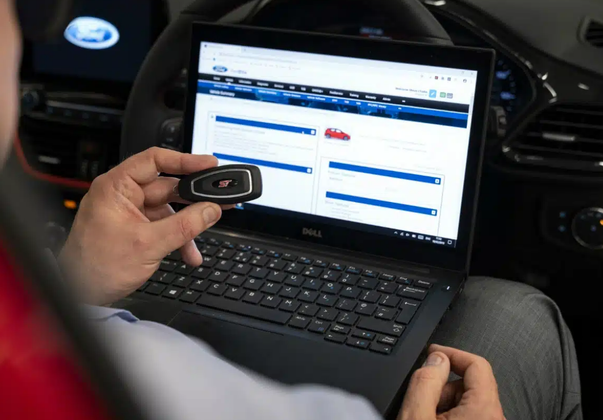 Alt Text: "ABC Locksmith Ohio expert programming a car key with advanced equipment for seamless vehicle access"