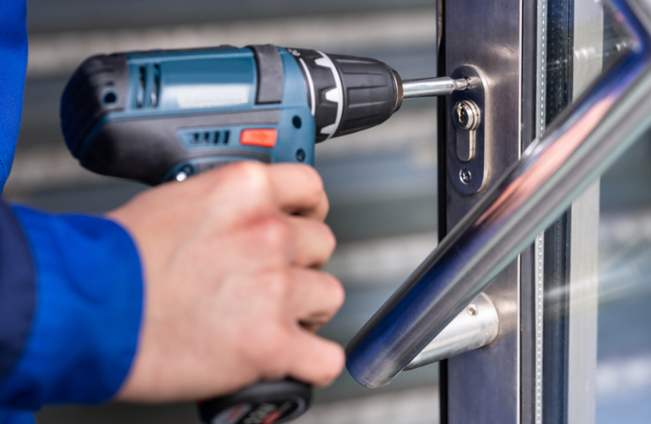 Image depicting a professional locksmith from ABC Locksmith Ohio installing a high-security lock on an office door, showcasing expertise in commercial security solutions.